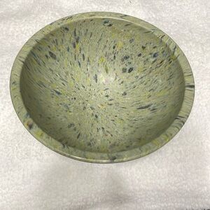 Melamine bowl.  Speckled green color with blue, yellow, black and red.